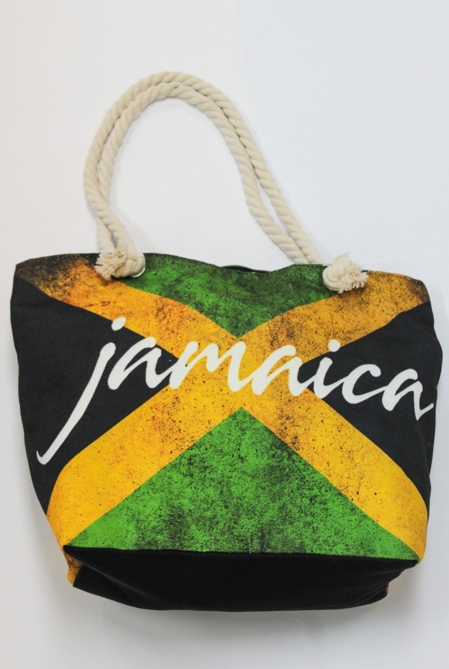 A tote bag with a rope handle featuring the Jamaican flag design and the word Jamaica across the front.